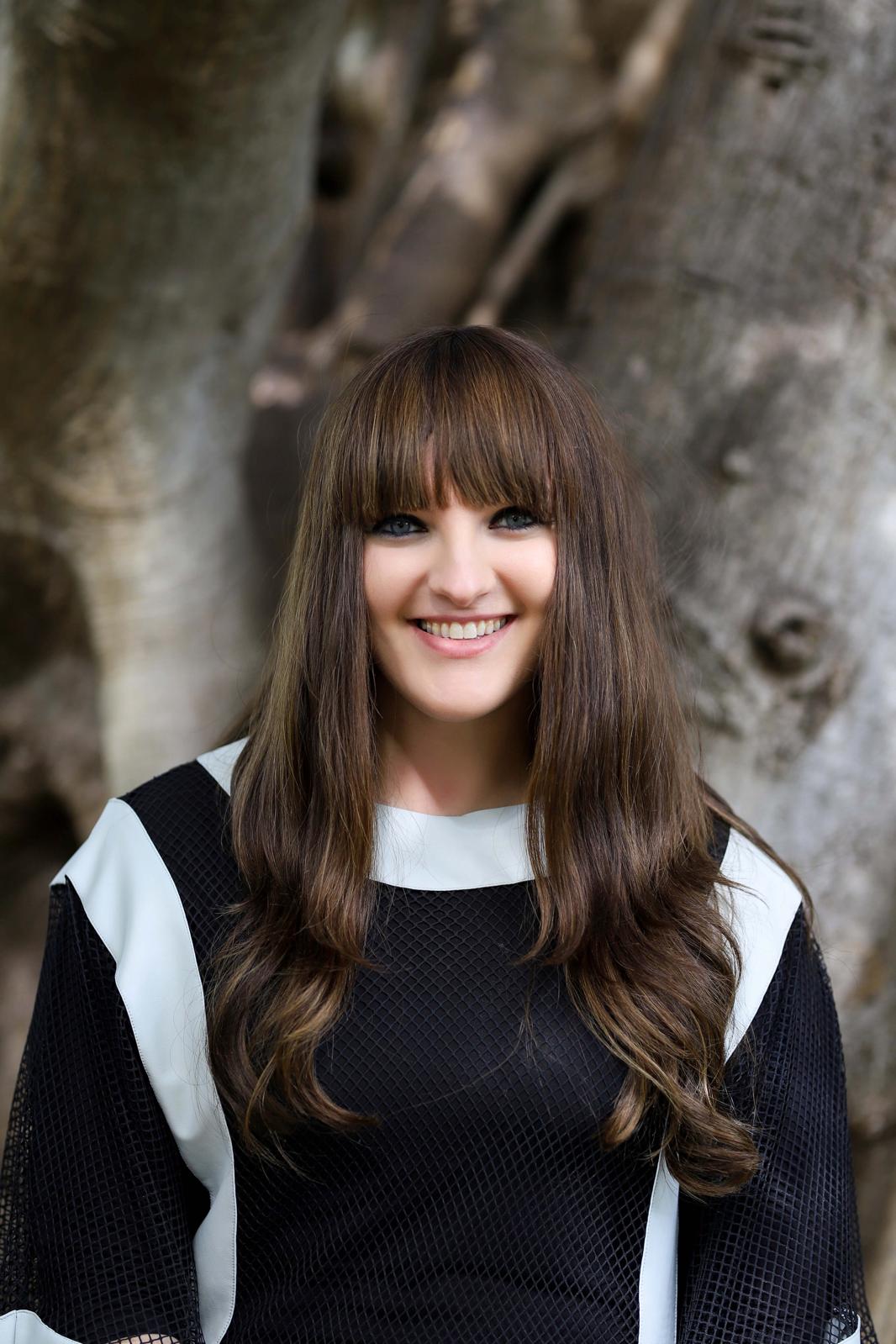 Gabrielle Charnowitz, President of Vacant No More, smiling warmly.